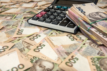 500 hryvnia bills with calculator as background. Close up. Top view