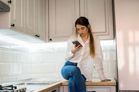portrait of young beautiful girl posing in the kitchen.の写真素材