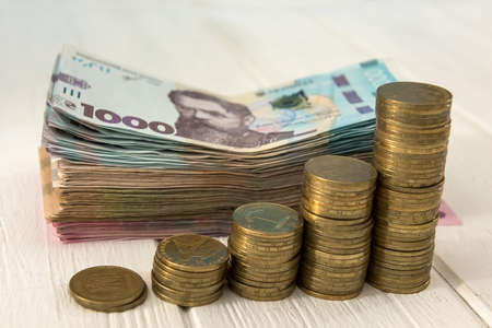 diagram of coin money growth effect with lot of ukraine money banknotes. For business growth and...