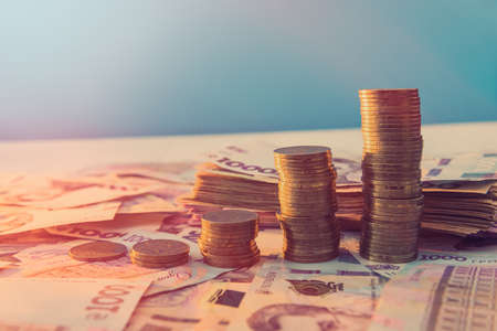 diagram of coin money growth effect with lot of ukraine money banknotes. For business growth and financial conceptの写真素材