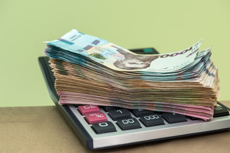 many ukraine money lying on calculator. 1000 banknotes. UAHの写真素材