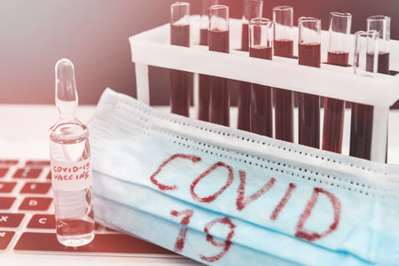 2019 new danger disease coronavirus (2019-nCoV). Fasical mask with blood test tube. Find virus vaccine concept.の写真素材