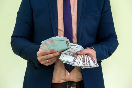 businessman gives a bribe or pay, in isolation. UAH. 1000 new banknote Ukrainian money