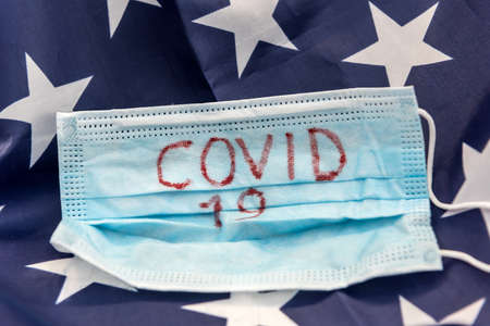 covid 19 outbreak worldwide. protective mask with text coronavirus on flag of usa. epidemic