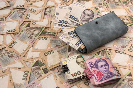 women's wallet money in cash Ukrainian hryvnia.の写真素材