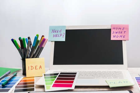 laptop with designer color swatches on the working place.