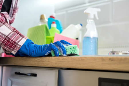 Cleaning concept. Woman washes and cleans in the kitchen.