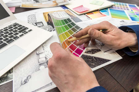 Designer working with home sketch and color sampler for modern interior. Archtercture project,...