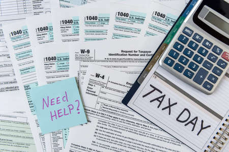 Tax form 1040 with notepad and text tax time, pen and calculator. Tax concept