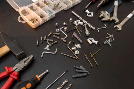 set of different tools with drill bits, screws, screwdriver bits and hexagon wrench for repair on...