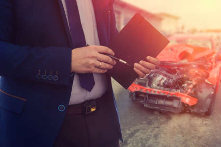 the manager accepts the broken car for repair at the car dealership.の写真素材