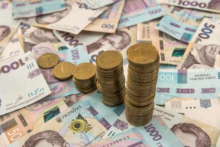 diagram of coin  money growth effect with lot of ukraine money banknotes. For business growth and financial conceptの写真素材