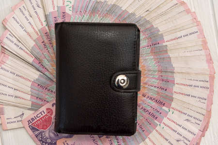UAH, Black men's wallet is full of money. UAH Money of Ukraine 1000 and 500 banknotes on desk. money and save conceptの写真素材