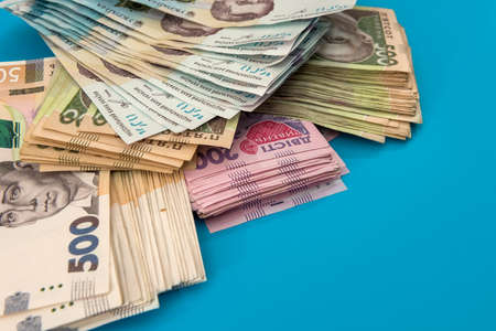 Ukrainian hryvnia money new bills 1000 and 500 isolated on blue. Stack of money. UAHの写真素材