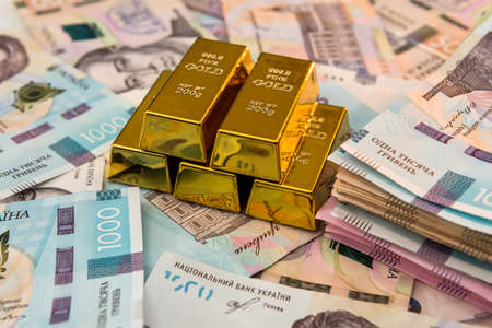 Gold bars on new banknote of Ukraine 1000 ad background. Save and money concept. Ukrainian Money.