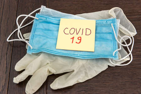 Medical disposable face mask with text covid-19. Coronavirus who causes pneumonia. Worldwide quarantine. diseaseの写真素材