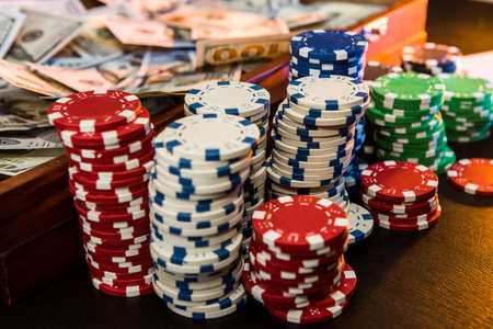 game and entertainment concept - many different casino chips on play table surface. close upの写真素材