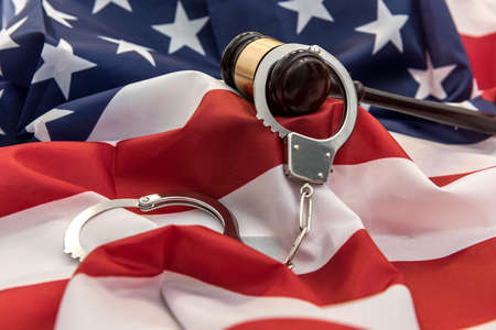 Gavel and handcuff lying flag of usa. Illegal concept. justiceの写真素材