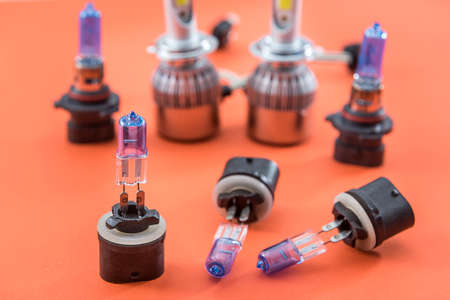 Different shapes and sizes car light bulbs isolated on orange. Modern auto glass lamp. energy power
