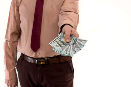 Businessman buying or renting a product or service, giving dollars, isolated on white. The male hand...
