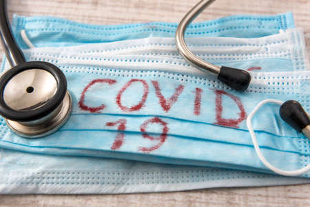 Medical protective mask with CORONA VIRUS, covid-19, crown virus, health stethoscope. Epidemic.の写真素材