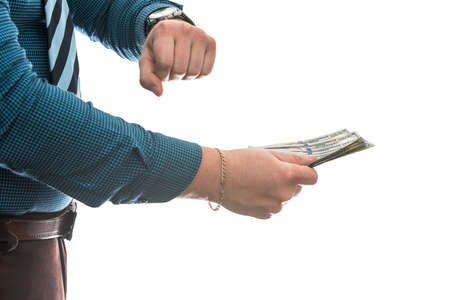 Man's hand in suit giving us dollar isolated on white background. Close up.