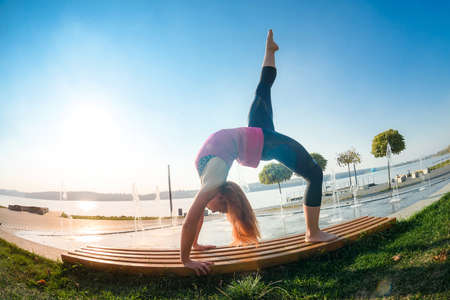 Young woman streching legs early morning before working time on outdoor.の写真素材