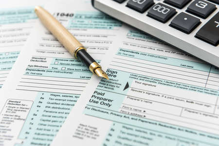 1040 tax form with pen, finance document.Paperwork