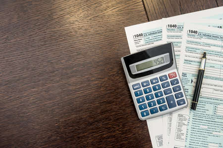 Tax Forms with Calculator and Pen. financial accounting. paperwork