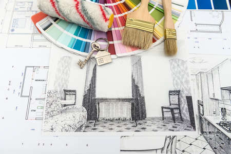 On office desk house sketch with color sample and brush. Workplace Architect. Drawing renovation...