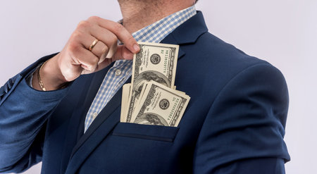 business man in a suit holds dollars, lot of money, isolated. finance concept