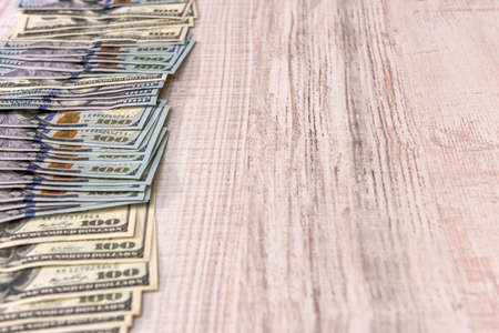 Dollar banknotes in fan on wooden table close upの写真素材