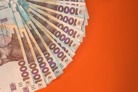 new 1000 banknote of 2020 year, ukraine money uah isolated on orange. save concept.の写真素材