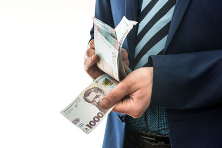 man in suit counts profits. men's hands convert hryvnia. 1000 new banknotes, Ukrainian moneyの写真素材