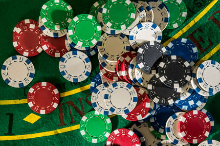 game and entertainment concept - many different casino chips on play table surface. close upの写真素材