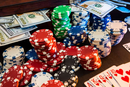 poker combination - card chips and money on the black table.