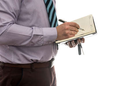 businessman signs purchase or lease agreement or filling notepad isolated white backgroundの写真素材