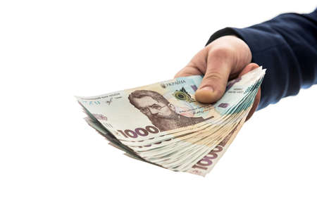 businessman gives a bribe or pay, in isolation. UAH. 1000 new banknote Ukrainian moneyの写真素材