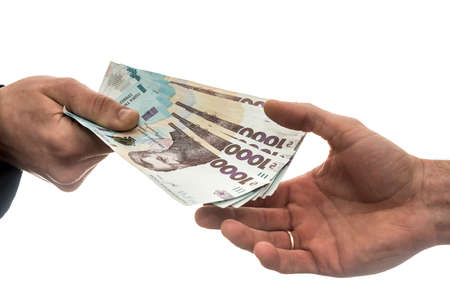 businessman gives or takes a bribe of money. Ukrainian hryvnia, new banknotes of 1000 hryvnia. Save or corruptionconcept.の写真素材