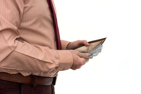 Businessman in suit gets us money from the wallet, isolated. Male hands holding a black leather...