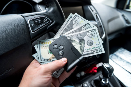 all for trip - auto dollar and car key in male's hand. finance conceptの写真素材