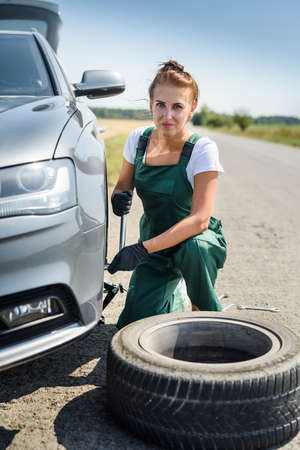 Woman in uniform working for car brake maintenance. Car repair. Safety workの写真素材