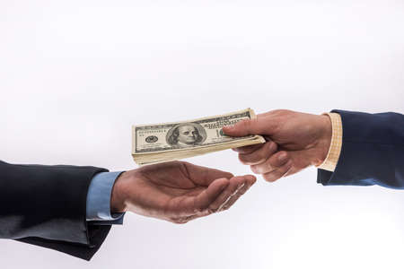 hands giving 100 dollar bills isolated. transfer moneyの写真素材
