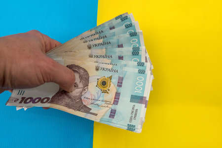 1000 new banknote of Ukraine on yellow blue background. Save and money cocncept. Ukrainian Money.