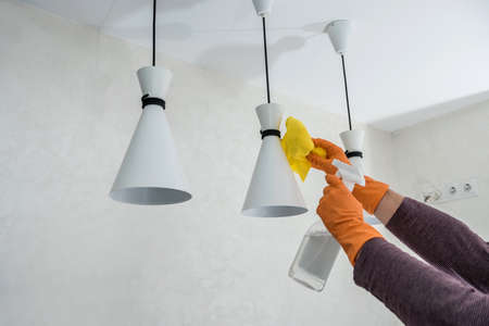 wife in the kitchen wipe in yellow gloves, cleaning for care and protect yourself. hygiene housework