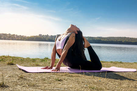 beautiful young woman doing stretching excercise before working time in the morning at park