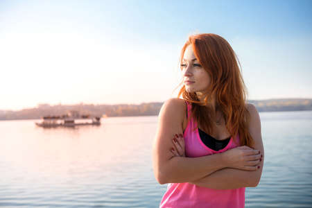 beautiful girl relaxing after morning gymnastics by the lake. health and beauty conceptの写真素材
