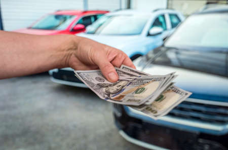 Money to buy the new car. Financial concept. Dollar in handの写真素材