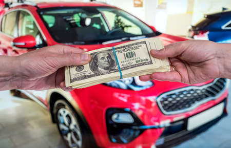 purchase new acr concept. man holding dollar for rent auto. financeの写真素材