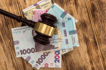ukraine money uah with wooden hammer, corruption concept. lawの写真素材